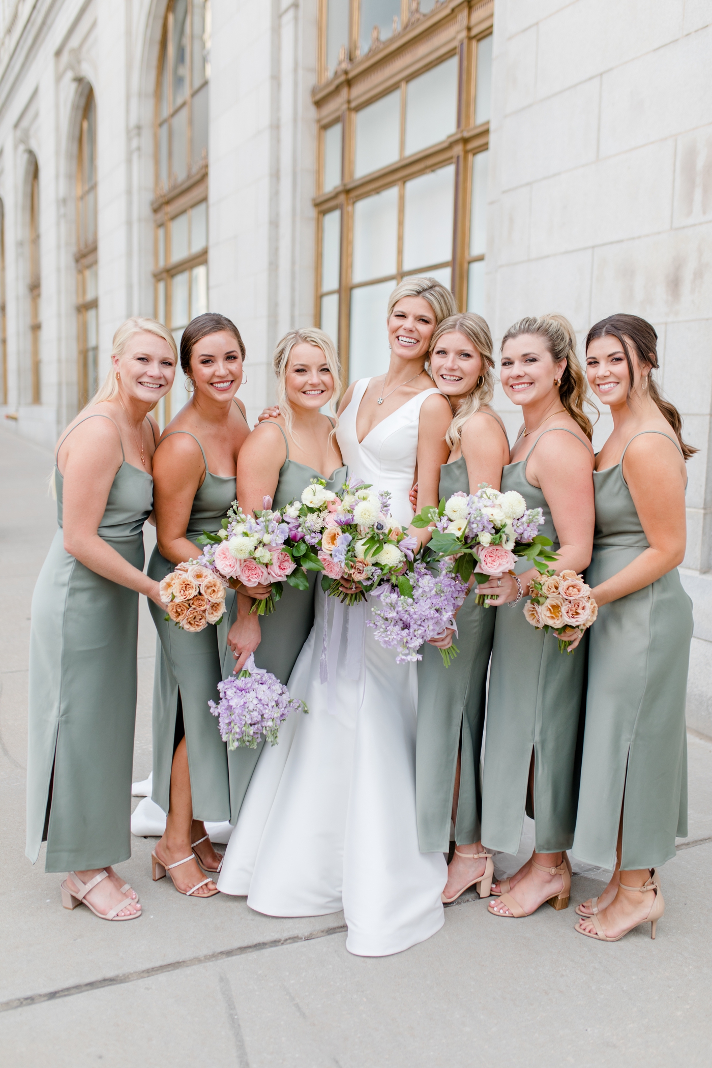 Sage green satin bridesmaids dress with pastel bouquets