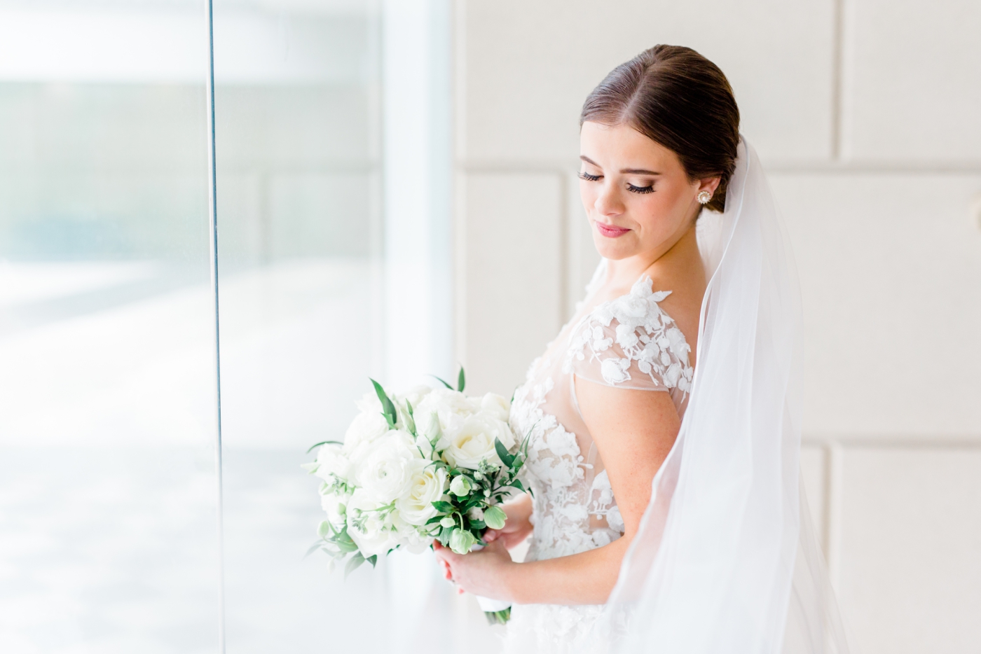 Bride in a Berta gown with white bridal bouquet
