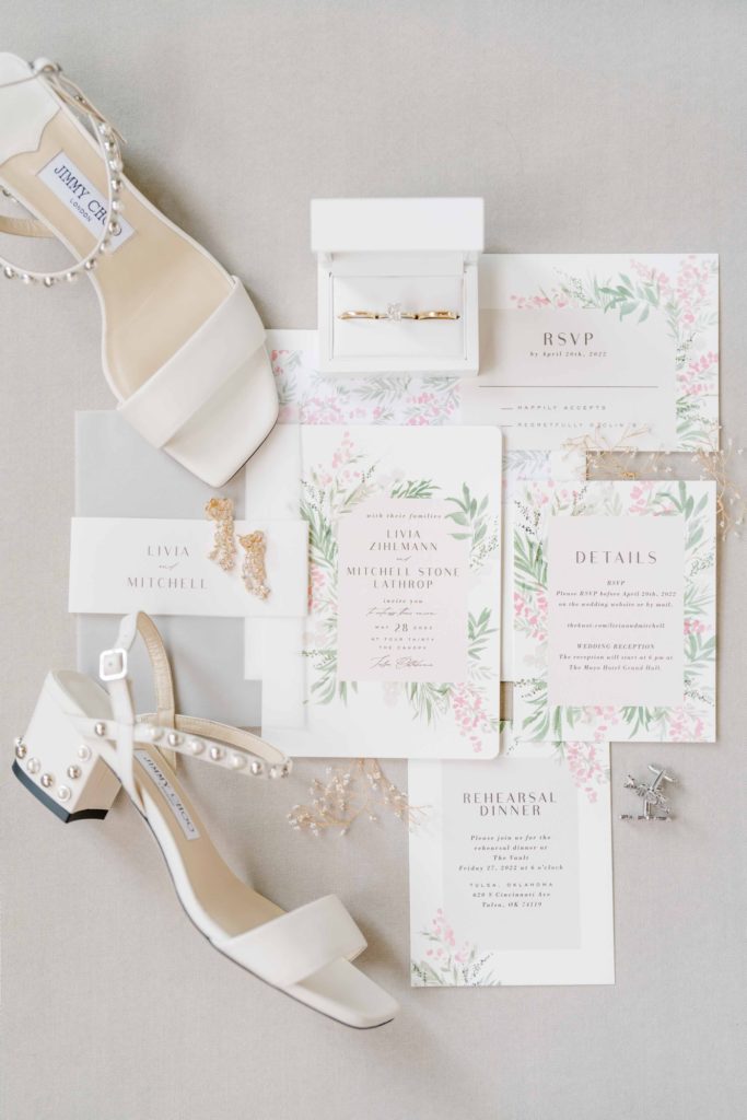Watercolor wedding invitations flat lay, with pearl bridal shoes