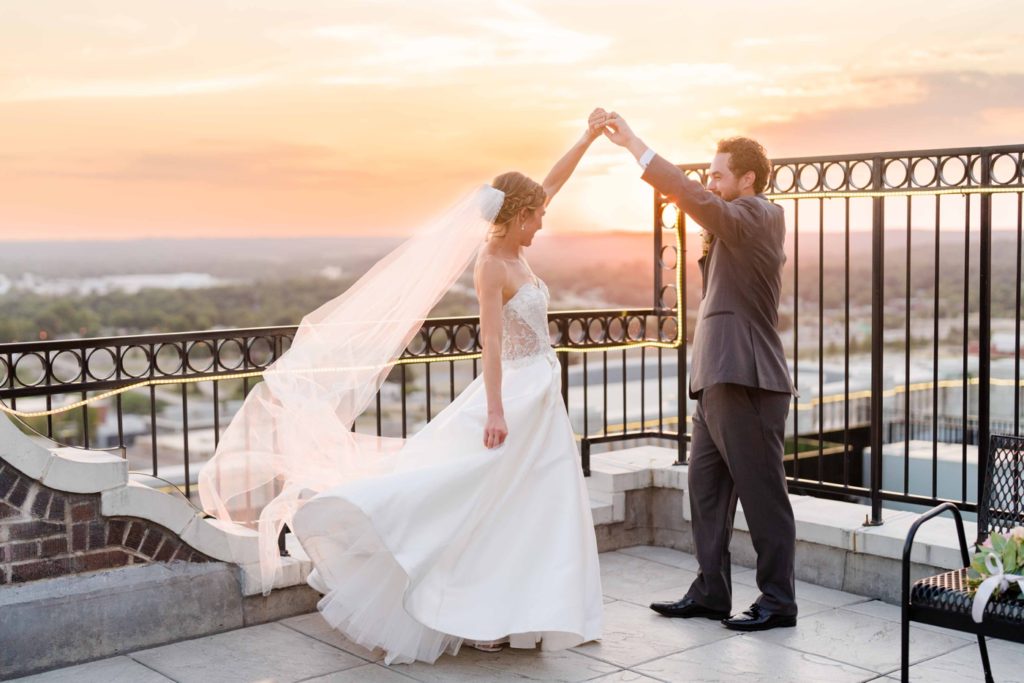 Sunset bride and groom portraits on the rooftop of The Mayo Hotel for their colorful wedding