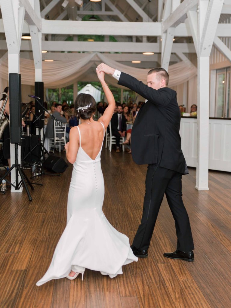 Bride and groom first dance during wedding reception at Spain Ranch