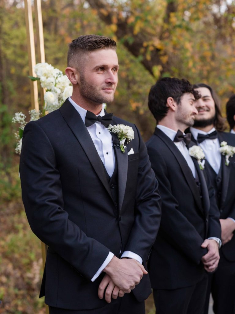 Groom looking at bride during wedding ceremony at Spain Ranch
