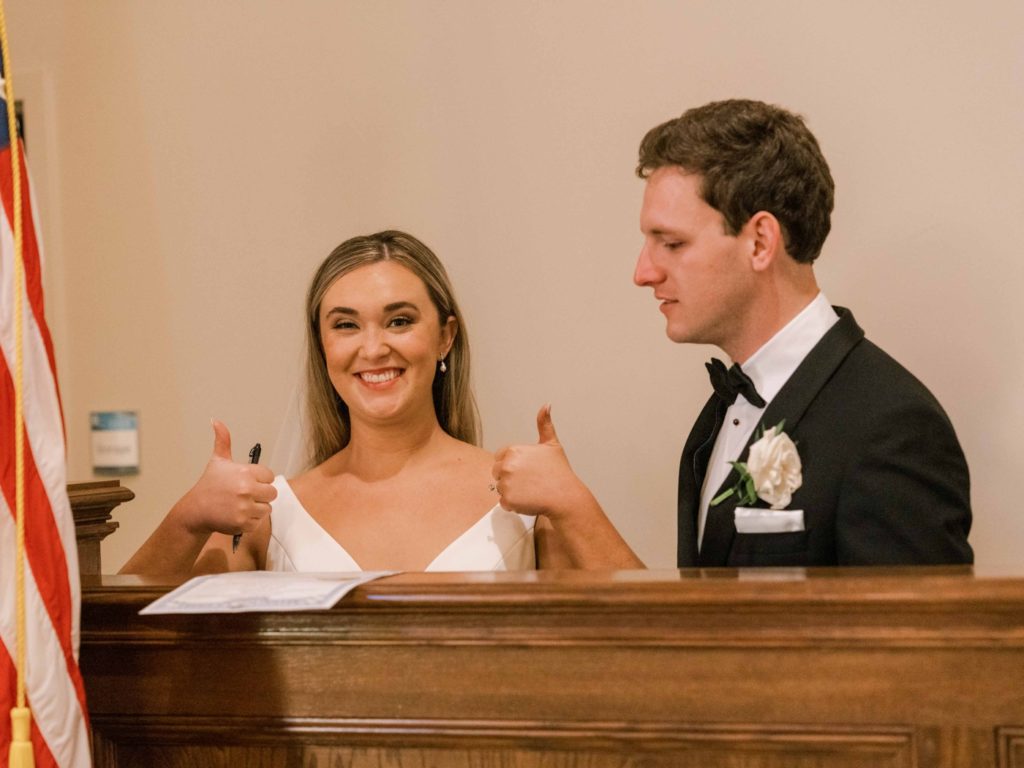 Bride and groom signing marriage license at Ashbury Church 