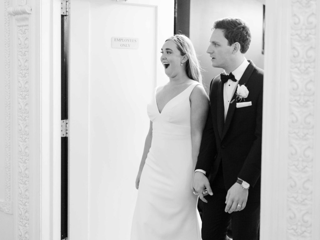 Bride and groom walking into wedding reception at Mayo Hotel