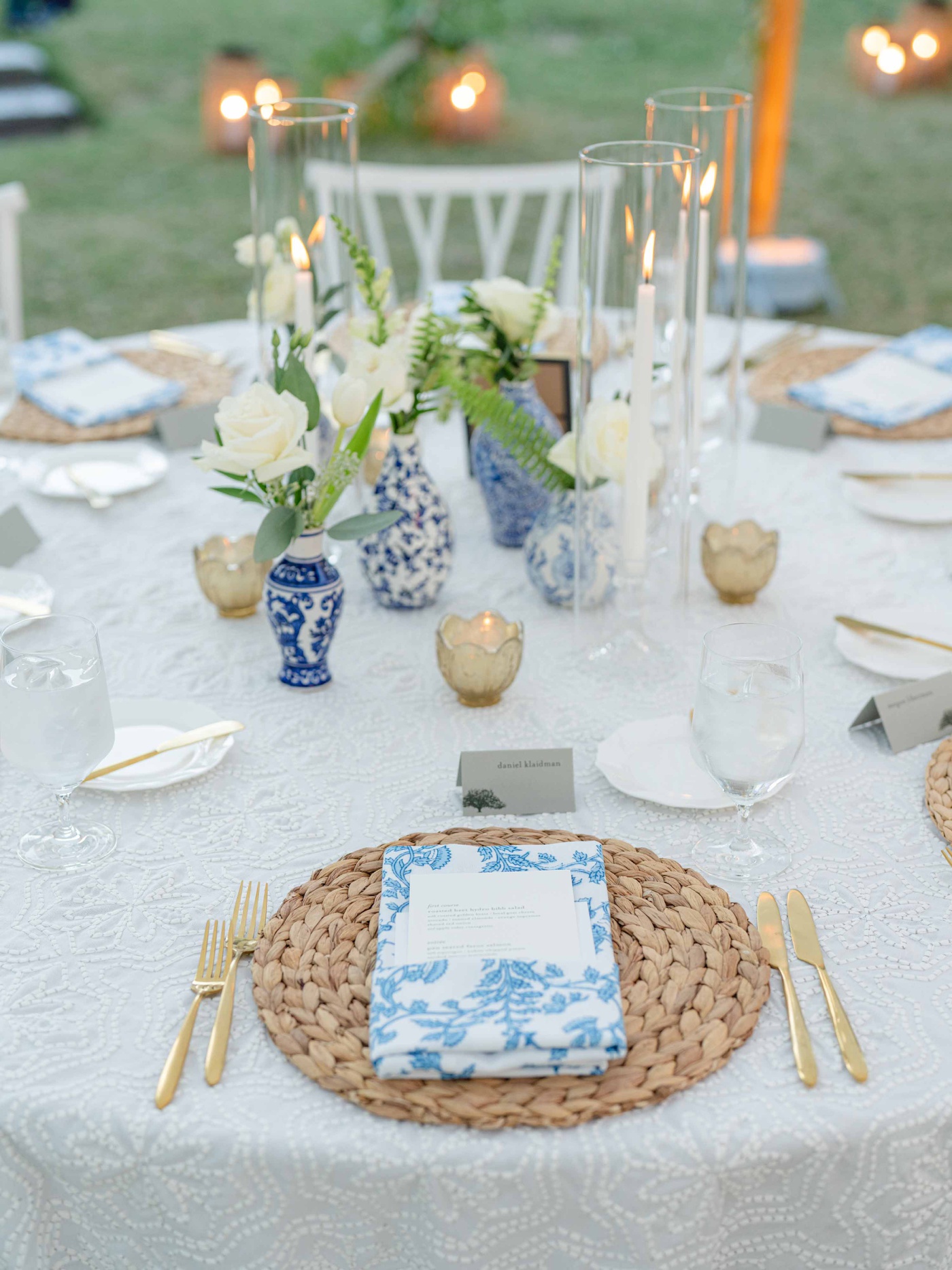 Place setting with a ginger jar patterned linen napkin on a round woven charger at a Lowcountry wedding