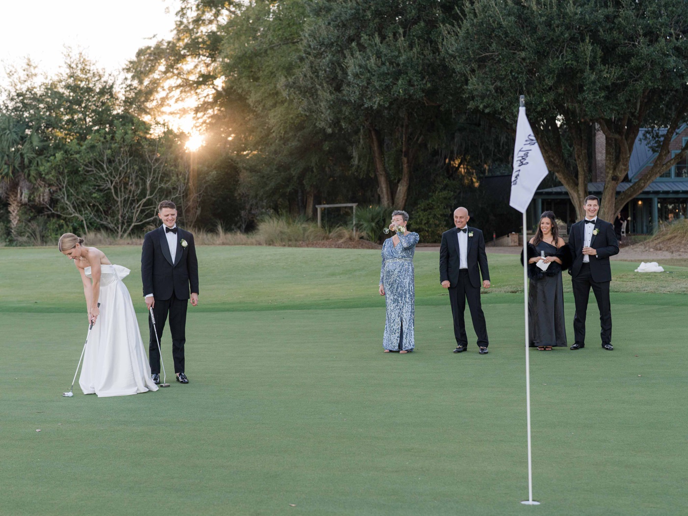 Bride and groom golfing with their families at a Lowcountry wedding