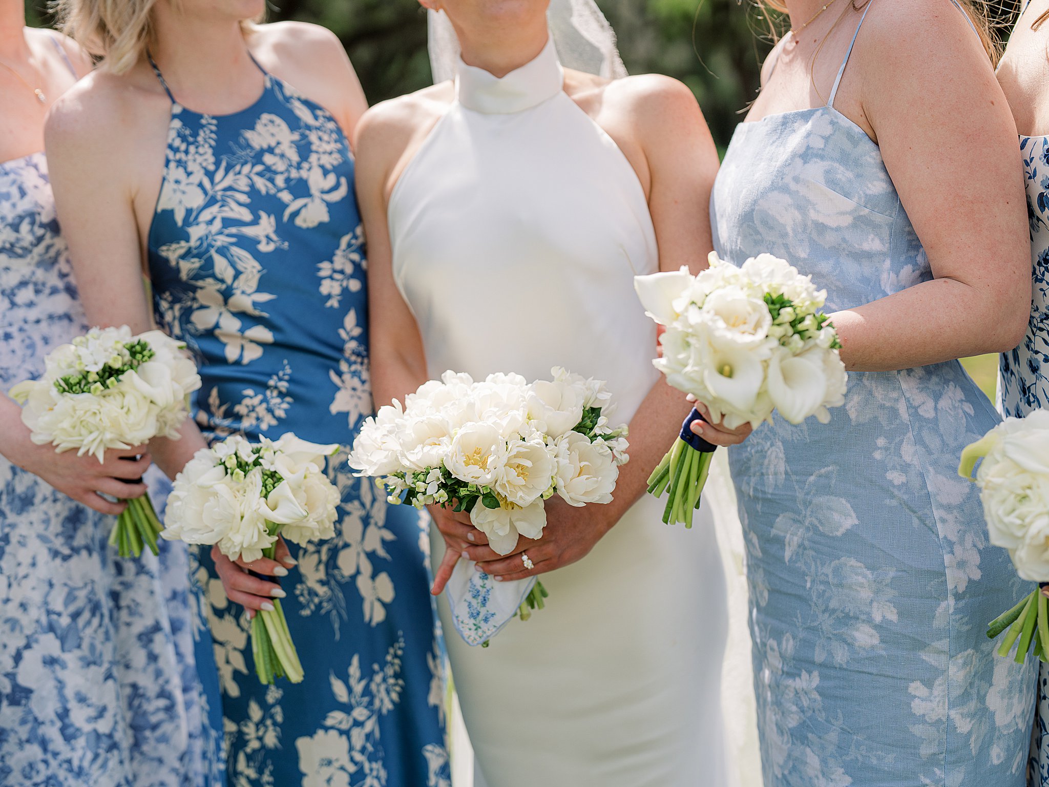 soft florals against blue bridesmaids dresses 