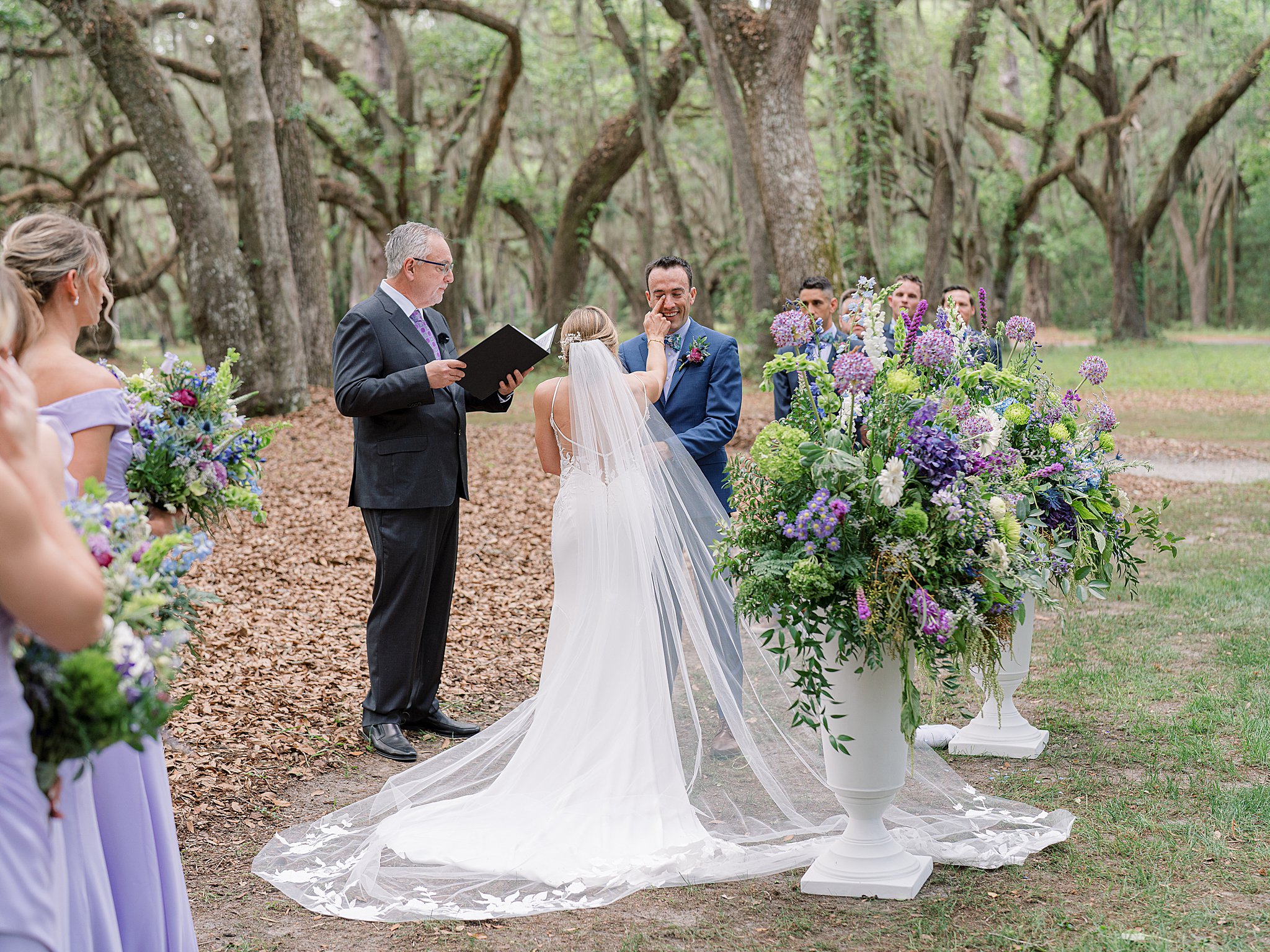 Carolyn and Greg exchanged vows overlooking the marsh, with sunlight dancing in the trees and loved ones gathered close.